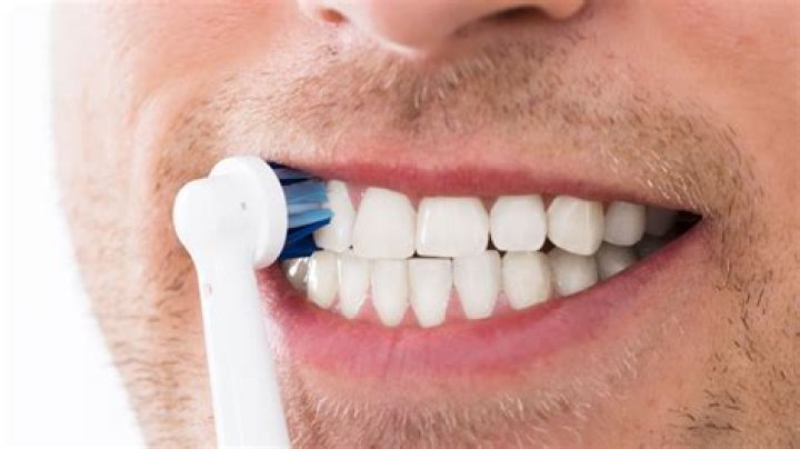 Should toothbrush touch gums?