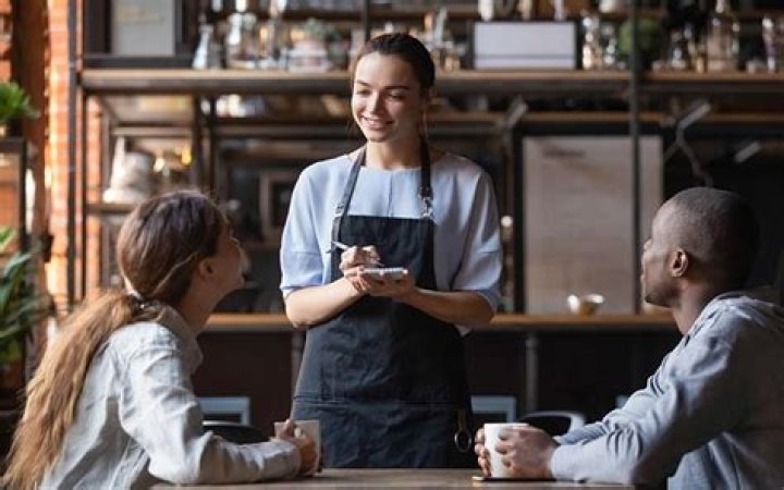 What does a greeter do at a restaurant?