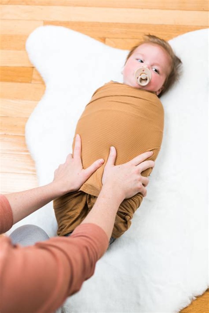 When to stop swaddling nhs?
